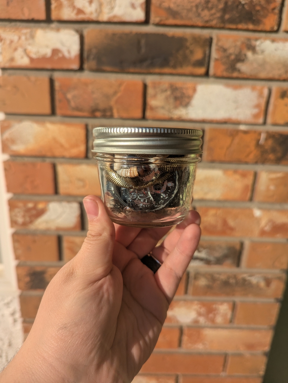 Clear Glass Jar Containing Jewelry